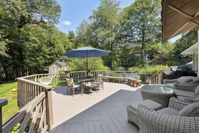 172 Mimosa Cir, Ridgefield, CT 06877 - wooden deck with outdoor dining area, a storage unit, area for grilling, and view of scattered trees