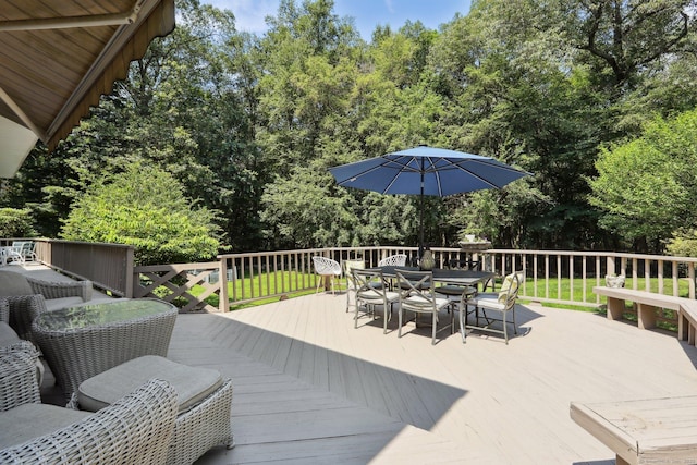 172 Mimosa Cir, Ridgefield, CT 06877 - wooden deck featuring outdoor dining area, view of wooded area, and a yard