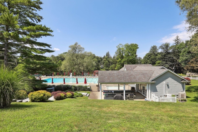 172 Mimosa Cir, Ridgefield, CT 06877 - back of property featuring a yard, a community pool, a patio, and roof with shingles