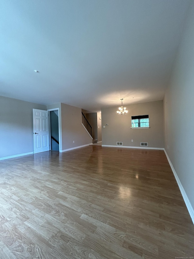 58 E Gate Ln Unit 58, Hamden, CT 06514 - unfurnished living room with a chandelier, wood finished floors, and stairway