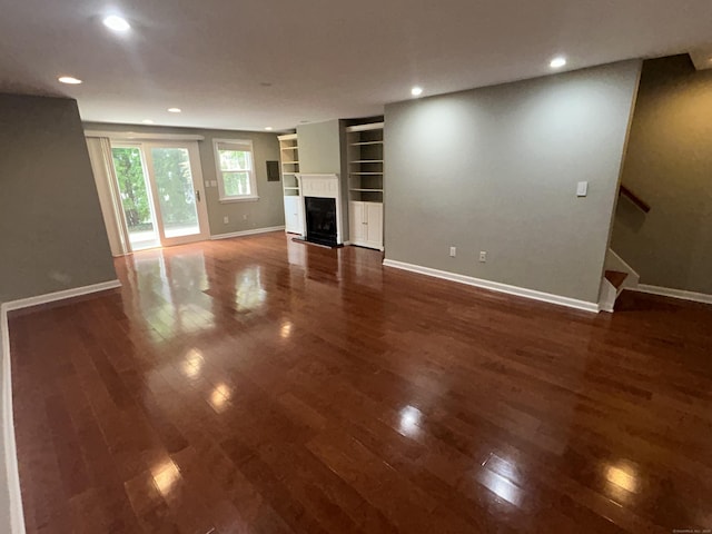 58 E Gate Ln Unit 58, Hamden, CT 06514 - unfurnished living room featuring wood finished floors, a fireplace, built in features, recessed lighting, and stairway