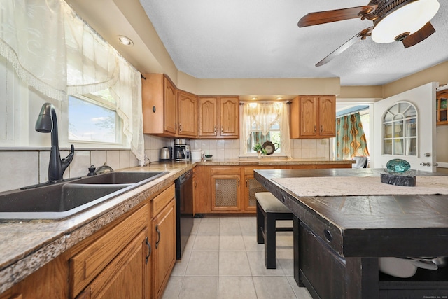 229 Hauser St, Waterbury, CT 06704 - kitchen featuring dishwasher, backsplash, brown cabinets, and light countertops