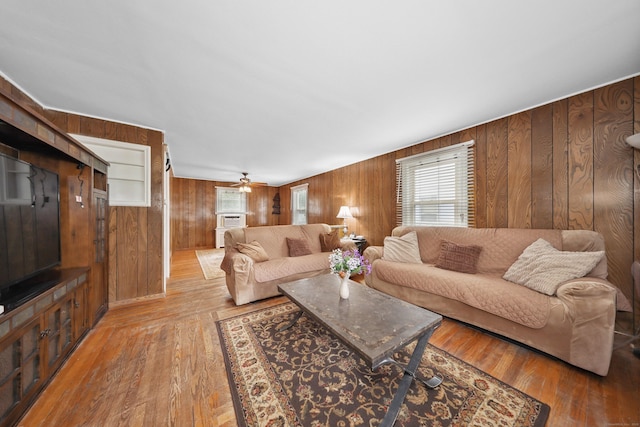 229 Hauser St, Waterbury, CT 06704 - living room featuring wooden walls, wood-type flooring, and a ceiling fan