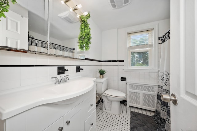 229 Hauser St, Waterbury, CT 06704 - full bath with radiator heating unit, vanity, tile patterned flooring, and tile walls