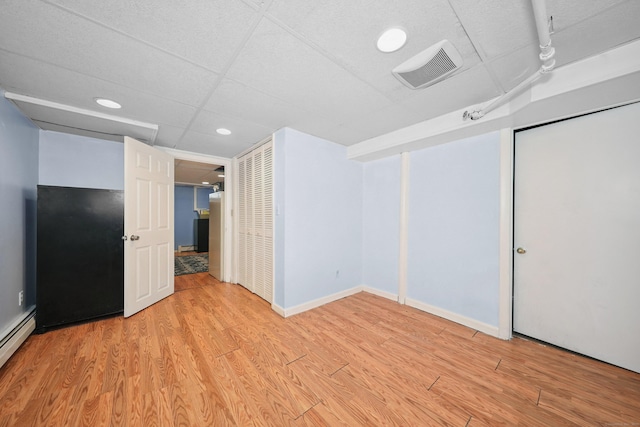 229 Hauser St, Waterbury, CT 06704 - unfurnished bedroom with light wood-style flooring, recessed lighting, and a baseboard radiator