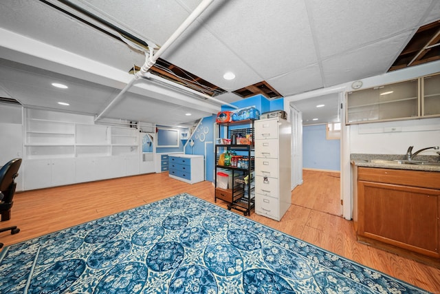 229 Hauser St, Waterbury, CT 06704 - finished basement with light wood-type flooring, wet bar, and recessed lighting