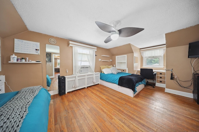 229 Hauser St, Waterbury, CT 06704 - bedroom with light wood-type flooring, multiple windows, vaulted ceiling, a textured ceiling, and a ceiling fan