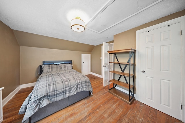 229 Hauser St, Waterbury, CT 06704 - bedroom featuring attic access, vaulted ceiling, and wood finished floors