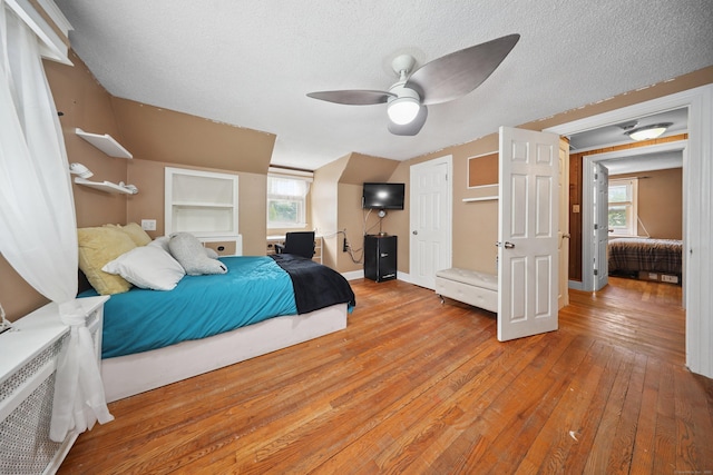 229 Hauser St, Waterbury, CT 06704 - bedroom featuring light wood finished floors, multiple windows, a textured ceiling, and ceiling fan