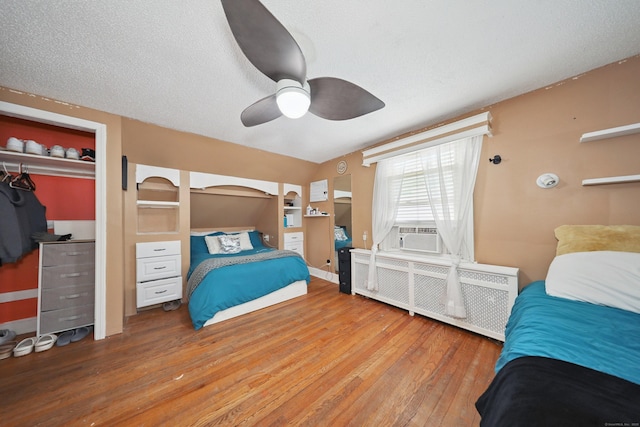 229 Hauser St, Waterbury, CT 06704 - bedroom featuring radiator, cooling unit, hardwood / wood-style flooring, a closet, and ceiling fan