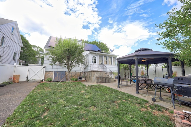 229 Hauser St, Waterbury, CT 06704 - rear view of property featuring a gate, a gazebo, a patio, and solar panels