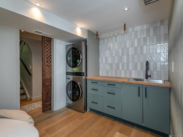 40 Revere Rd, Washington, CT 06793 - washroom with stacked washing machine and dryer, light wood-style flooring, and recessed lighting