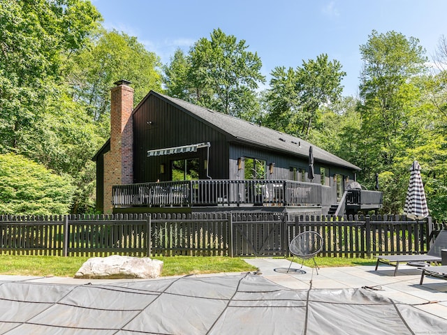 40 Revere Rd, Washington, CT 06793 - view of front of property featuring a deck and a chimney