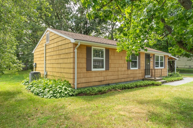 18 Saint Joseph Ct, Groton, CT 06340 - view of front facade with a front yard and a shingled roof