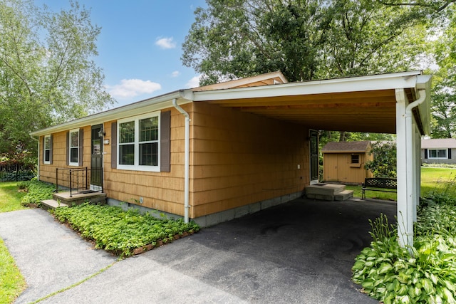 18 Saint Joseph Ct, Groton, CT 06340 - view of side of home with a storage unit and a carport