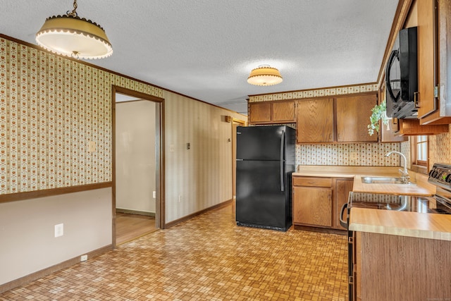 18 Saint Joseph Ct, Groton, CT 06340 - kitchen with black appliances, light countertops, light flooring, crown molding, and brown cabinetry