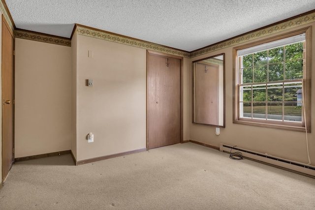 18 Saint Joseph Ct, Groton, CT 06340 - unfurnished bedroom with a textured ceiling, light colored carpet, a closet, and a baseboard heating unit