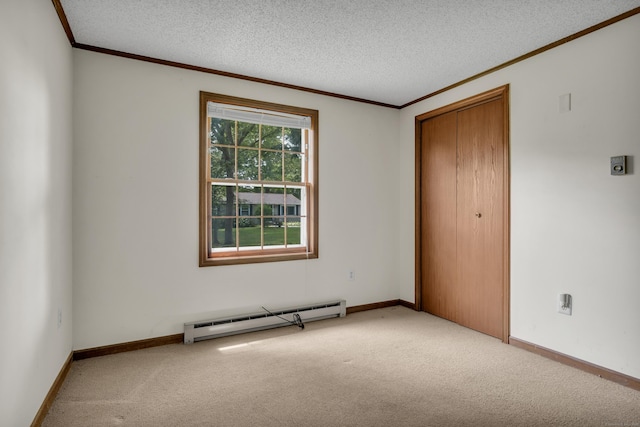 18 Saint Joseph Ct, Groton, CT 06340 - unfurnished bedroom featuring baseboard heating, carpet flooring, crown molding, a closet, and a textured ceiling