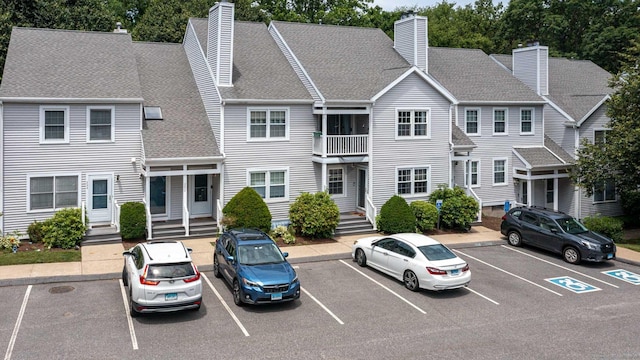 286 Laura Blvd Unit 286, Norwich, CT 06360 - view of front of property with a chimney, uncovered parking, and roof with shingles
