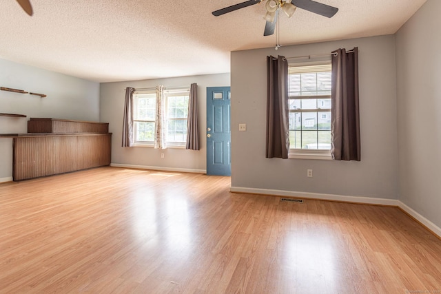 286 Laura Blvd Unit 286, Norwich, CT 06360 - unfurnished living room featuring ceiling fan, wood finished floors, and a textured ceiling