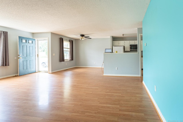 286 Laura Blvd Unit 286, Norwich, CT 06360 - unfurnished living room with a ceiling fan, light wood-style flooring, and a textured ceiling