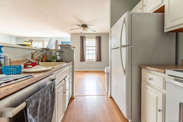 286 Laura Blvd Unit 286, Norwich, CT 06360 - kitchen with light wood-style floors, plenty of natural light, ceiling fan, range, and a textured ceiling
