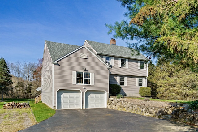 215 Upper Pattagansett Rd, East Lyme, CT 06333 - colonial inspired home featuring driveway, a chimney, roof with shingles, and an attached garage
