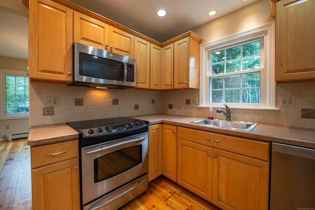 30 Streamview Cir, Guilford, CT 06437 - kitchen with appliances with stainless steel finishes, light wood-style flooring, a baseboard radiator, light countertops, and recessed lighting