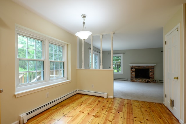 30 Streamview Cir, Guilford, CT 06437 - unfurnished living room featuring baseboard heating, light wood-style flooring, and a baseboard radiator