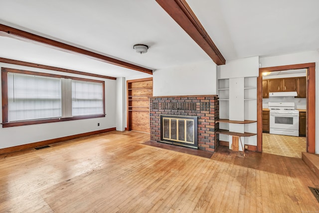 2 Scofield Pl, Norwalk, CT 06855 - unfurnished living room featuring beamed ceiling, light wood-type flooring, a brick fireplace, and built in features
