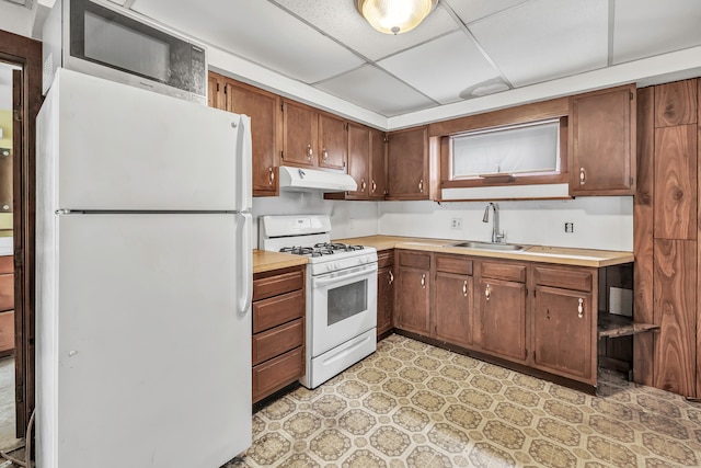2 Scofield Pl, Norwalk, CT 06855 - kitchen featuring white appliances, under cabinet range hood, light countertops, light floors, and a drop ceiling