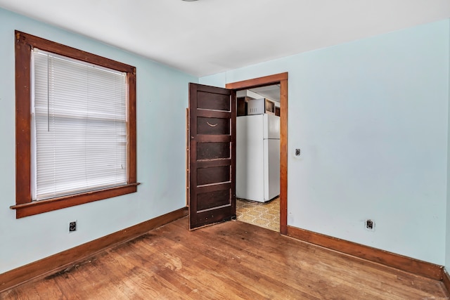 2 Scofield Pl, Norwalk, CT 06855 - unfurnished bedroom with freestanding refrigerator and light wood-style floors
