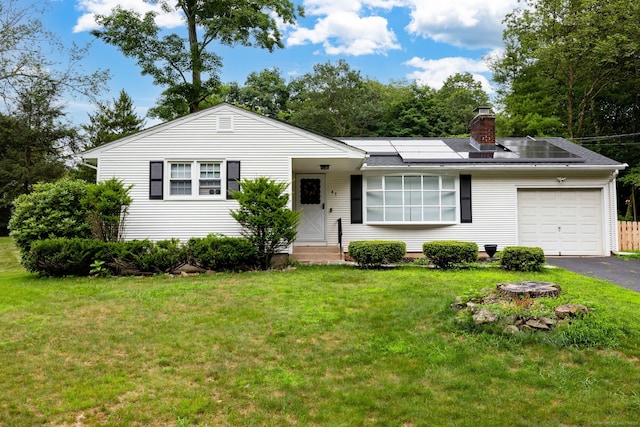 47 Dogwood Ln, Meriden, CT 06450 - ranch-style home featuring a garage, asphalt driveway, solar panels, a front lawn, and a chimney