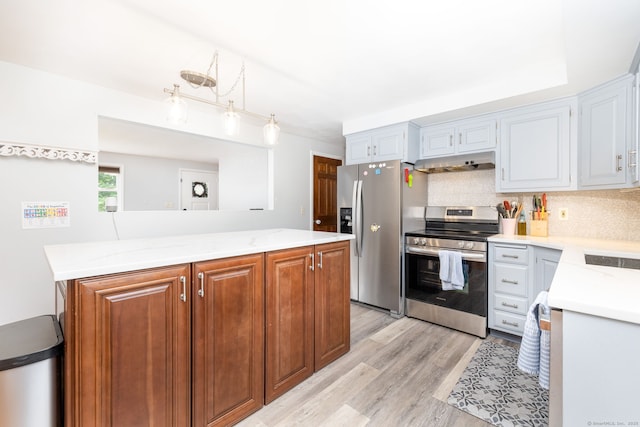 47 Dogwood Ln, Meriden, CT 06450 - kitchen featuring stainless steel appliances, light wood-style floors, tasteful backsplash, under cabinet range hood, and hanging light fixtures