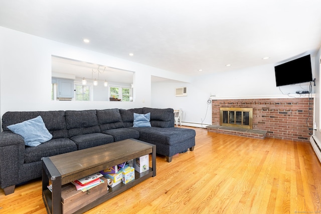 47 Dogwood Ln, Meriden, CT 06450 - living room featuring light wood-style flooring, a wall mounted air conditioner, a brick fireplace, and recessed lighting