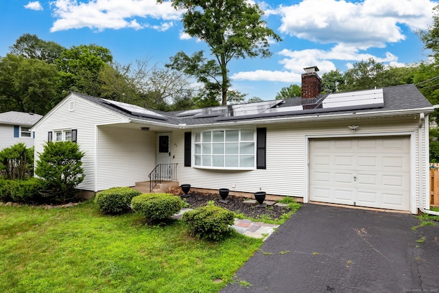 47 Dogwood Ln, Meriden, CT 06450 - ranch-style home with a chimney, a front yard, roof mounted solar panels, driveway, and a garage