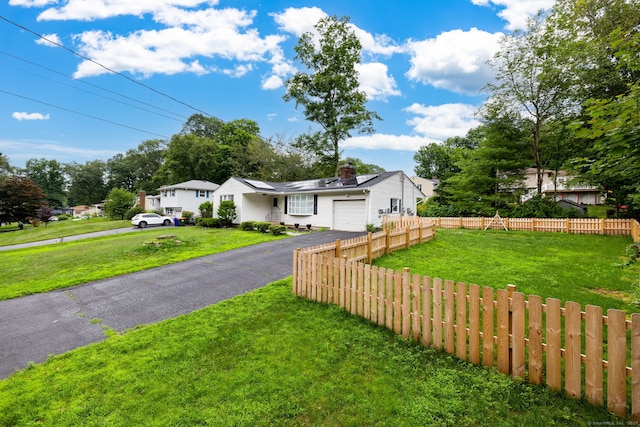 47 Dogwood Ln, Meriden, CT 06450 - view of front of home featuring asphalt driveway, a garage, and roof mounted solar panels