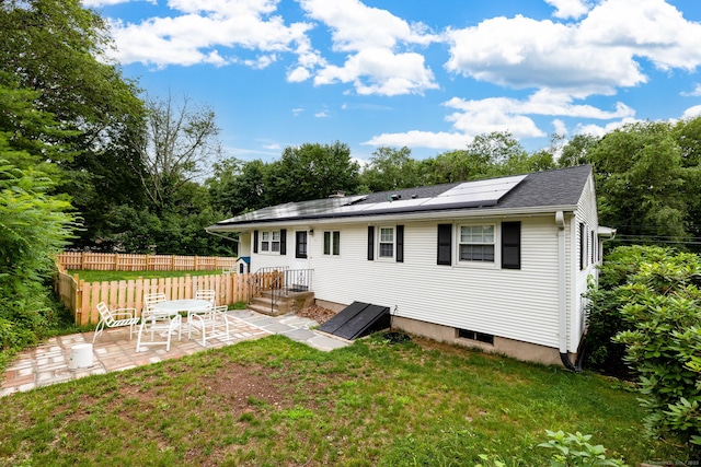 47 Dogwood Ln, Meriden, CT 06450 - back of house with a patio and roof mounted solar panels