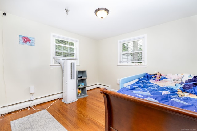 47 Dogwood Ln, Meriden, CT 06450 - bedroom featuring multiple windows, light wood finished floors, a baseboard heating unit, and a baseboard radiator