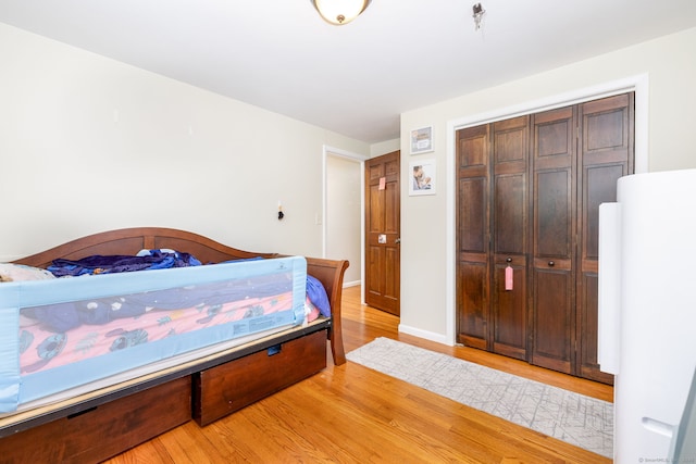 47 Dogwood Ln, Meriden, CT 06450 - bedroom with freestanding refrigerator, light wood-type flooring, and a closet