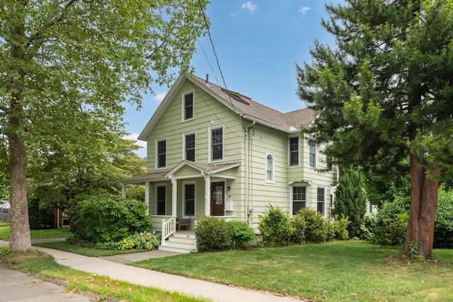 45 Graves Ave, Guilford, CT 06437 - traditional-style home with a shingled roof and a front lawn