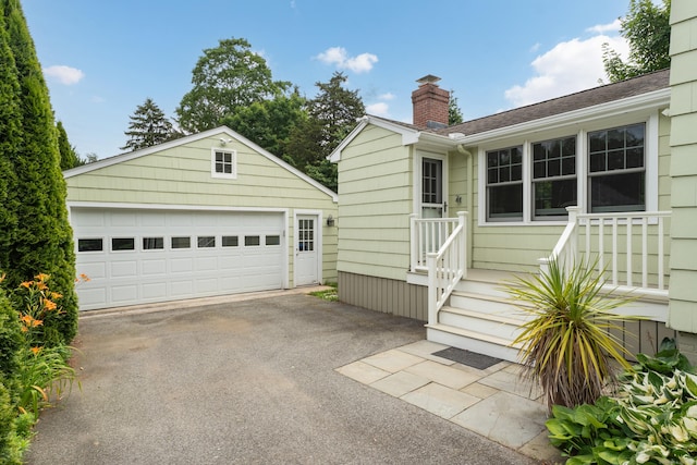45 Graves Ave, Guilford, CT 06437 - view of front of house with an outbuilding, a chimney, and a detached garage