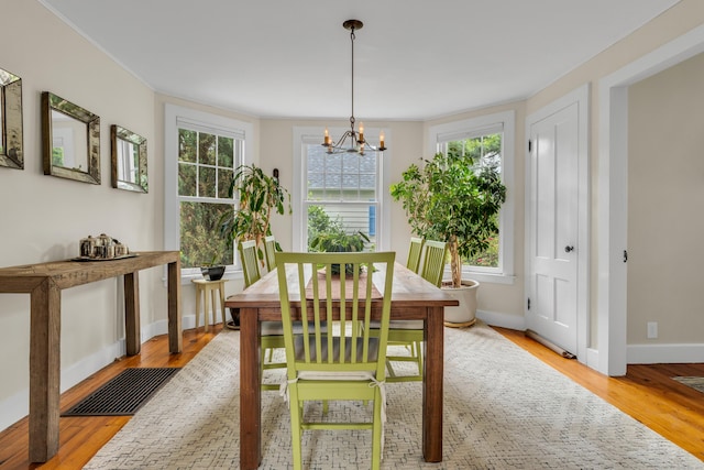 45 Graves Ave, Guilford, CT 06437 - dining space with a chandelier, plenty of natural light, wood finished floors, and ornamental molding