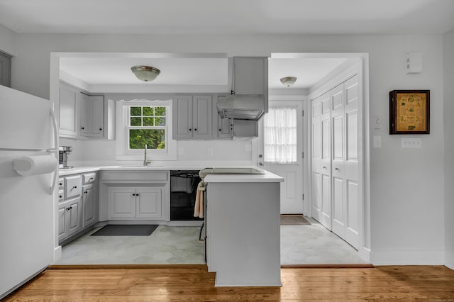 45 Graves Ave, Guilford, CT 06437 - kitchen with freestanding refrigerator, dishwasher, ventilation hood, gray cabinets, and light wood-style flooring