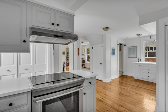 45 Graves Ave, Guilford, CT 06437 - kitchen featuring electric stove, under cabinet range hood, light countertops, light wood-style floors, and gray cabinets