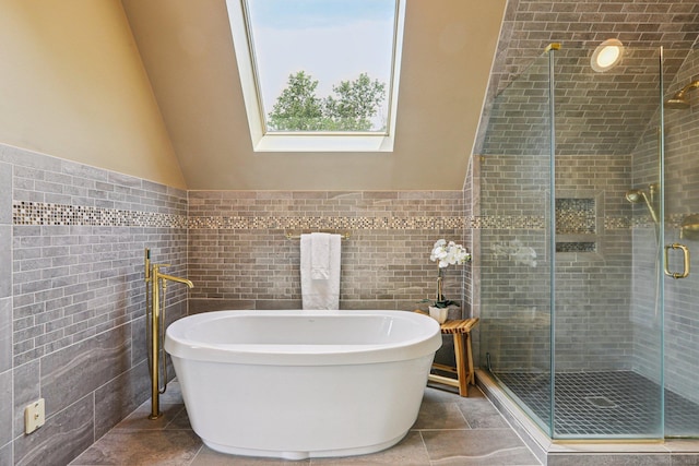 25 Encampment Pl, Ridgefield, CT 06877 - bathroom featuring tile walls, a soaking tub, a shower stall, vaulted ceiling, and a skylight