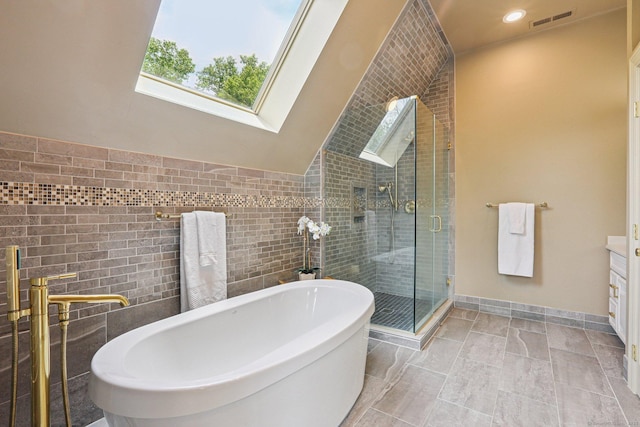 25 Encampment Pl, Ridgefield, CT 06877 - full bathroom with tile walls, a skylight, a freestanding tub, a stall shower, and vanity