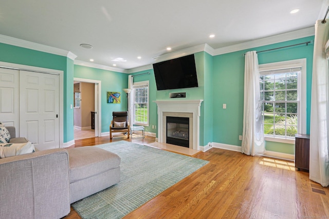 25 Encampment Pl, Ridgefield, CT 06877 - living area with a fireplace with flush hearth, ornamental molding, wood finished floors, and recessed lighting