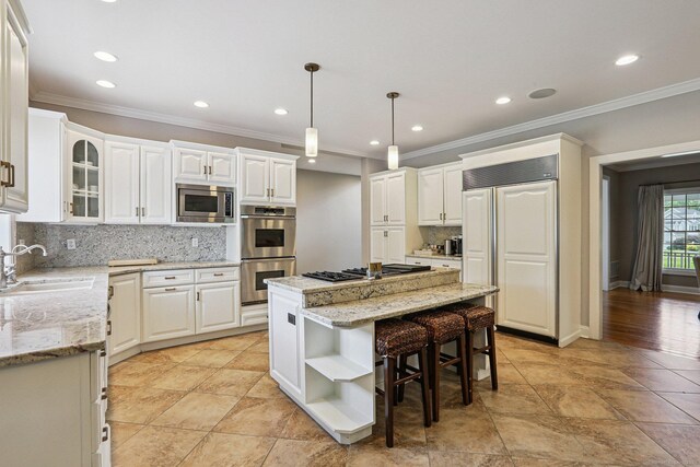 25 Encampment Pl, Ridgefield, CT 06877 - kitchen with built in appliances, a center island, open shelves, tasteful backsplash, and ornamental molding