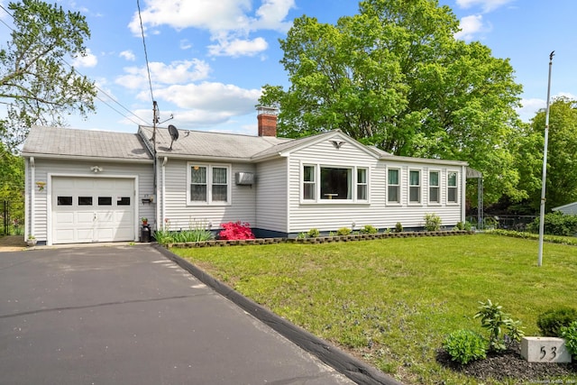 53 Cleveland St, Putnam, CT 06260 - view of front of house featuring an attached garage, a chimney, asphalt driveway, and a wall mounted air conditioner